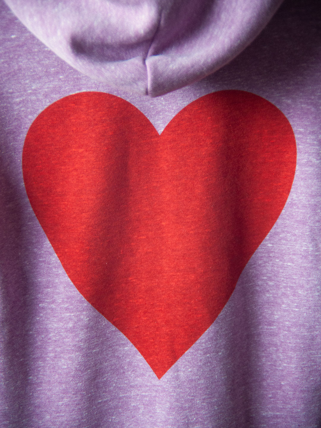 purple hoodie with red heart printed on the back