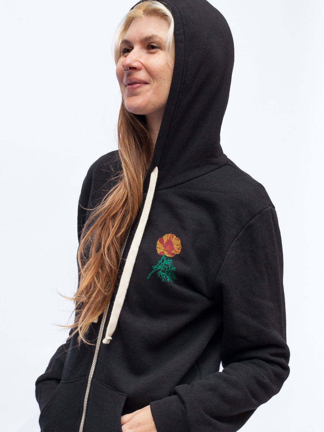 Person wearing a black hoodie with a colorful design on a white background